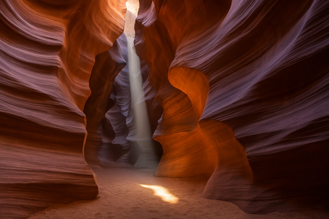 A beam of sunlight inside the curving sandstone walls of Antelope Canyon